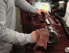 Vacuum repair technician cleaning and servicing a vacuum motor in Manchester, NH